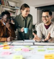 Happy creative marketing team working on new business project in the office.